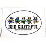 Oval-shaped white sticker featuring five vibrant, cartoon-style bees in various colors, inspired by the 'Grateful Dead' bear designs, with black text that reads 'Bee Grateful'.